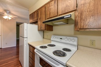 Kitchen with Hardwood Inspired Floors, Oven, Stove, Wood Cabinets and Refrigerator